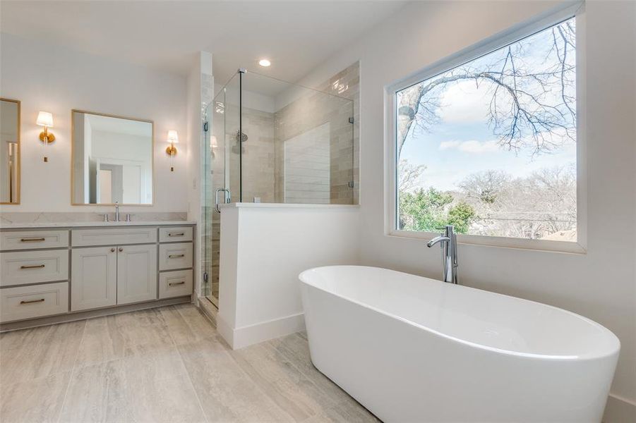 Bathroom featuring vanity and independent shower and bath