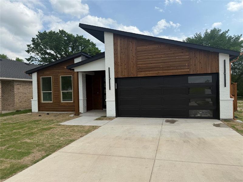 Front exterior of a new home in , Greenville, TX, highlighting curb appeal (Image 1). Front exterior of a new home in , Greenville, TX, highlighting curb appeal (Image 1).