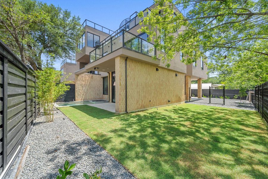 Modern architecture meets verdant landscaping in this private, fenced yard, offering ample space for outdoor enjoyment.