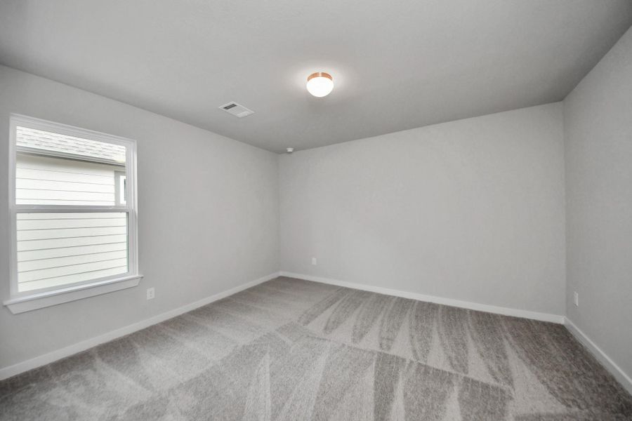 Secondary bedroom features plush carpeting, large windows that let in plenty of natural light, bright paint, and spacious closets. Secondary bedroom features plush carpeting, large windows that let in plenty of natural light, bright paint, and spacious closets.