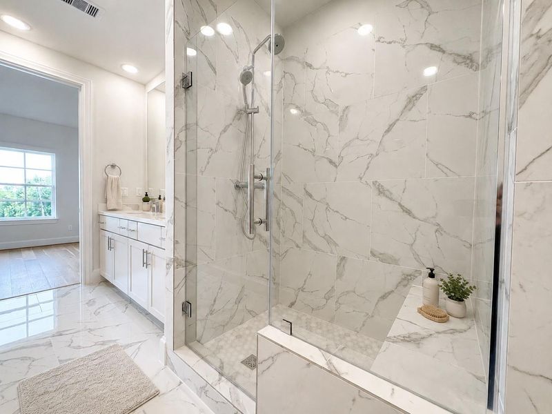 Stunning walk-in shower with luxury Hansgrohe plumbing fixtures in the primary bathroom. Virtual staging added. Stunning walk-in shower with luxury Hansgrohe plumbing fixtures in the primary bathroom. Virtual staging added.