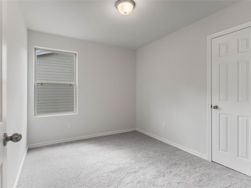 Cozy upstairs bedroom with plush carpeting.