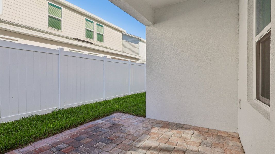 Exterior details and patio area of a home in Cyrene at Harmony, St. Cloud (Image 26).