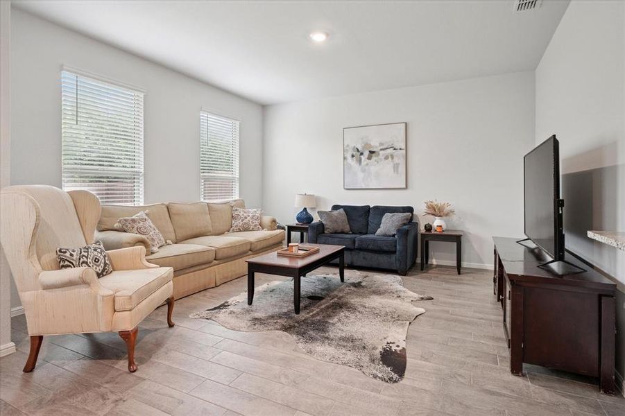 Spacious Living Room with an abundance of natural light and light wood-type flooring and recessed lighting. Spacious Living Room with an abundance of natural light and light wood-type flooring and recessed lighting.