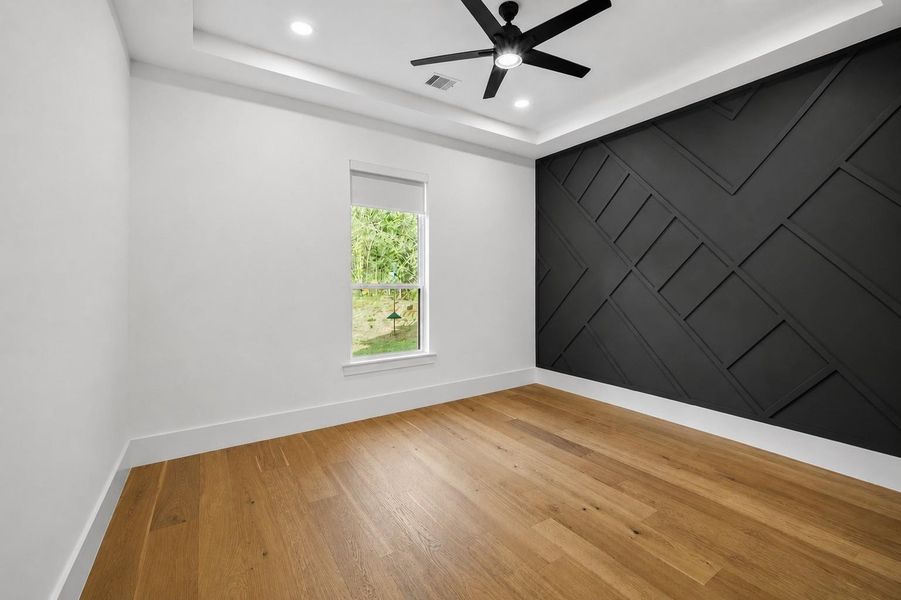 Spacious secondary bedroom with walk-in closet and private ensuite bathroom.