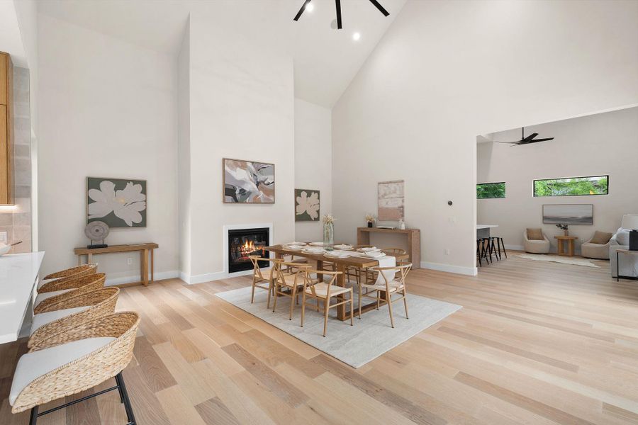 Open-concept living space featuring vaulted ceilings and light wood-finish flooring