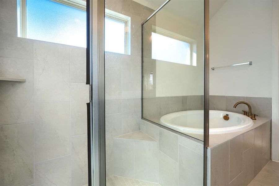 Bathroom with tile patterned floors and plus walk in shower