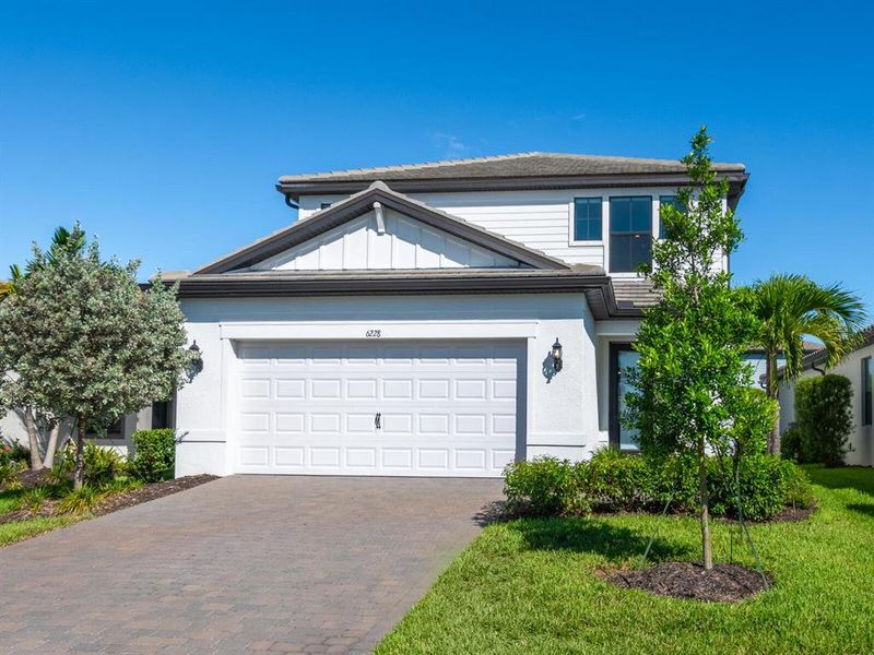 Front exterior of a new home in , Lakewood Ranch, FL, highlighting curb appeal (Image 22).