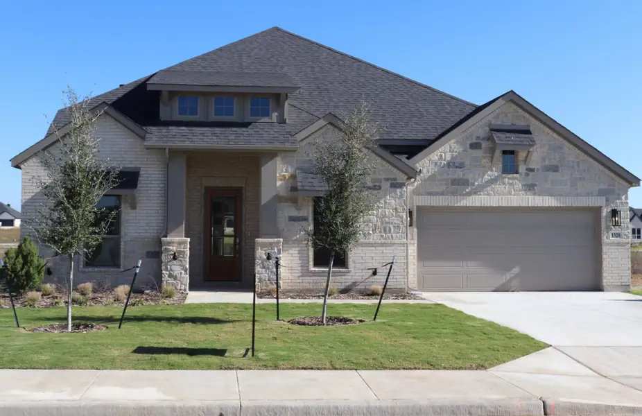 Front exterior of a new home in Bull Hide Estates, Hewitt, TX, highlighting curb appeal (Image 1). Front exterior of a new home in Bull Hide Estates, Hewitt, TX, highlighting curb appeal (Image 1).