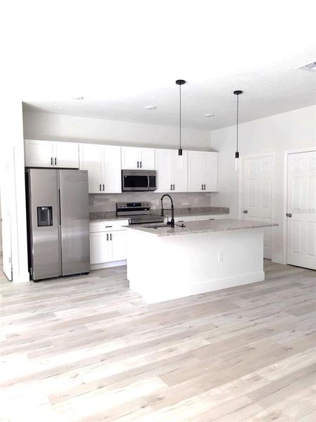 kitchen island and Samsung appliances