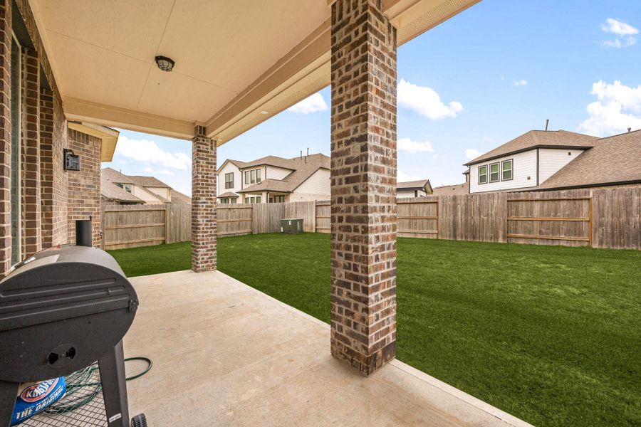 Exterior details and patio area of a home in Sunterra 60ft, Katy (Image 2).