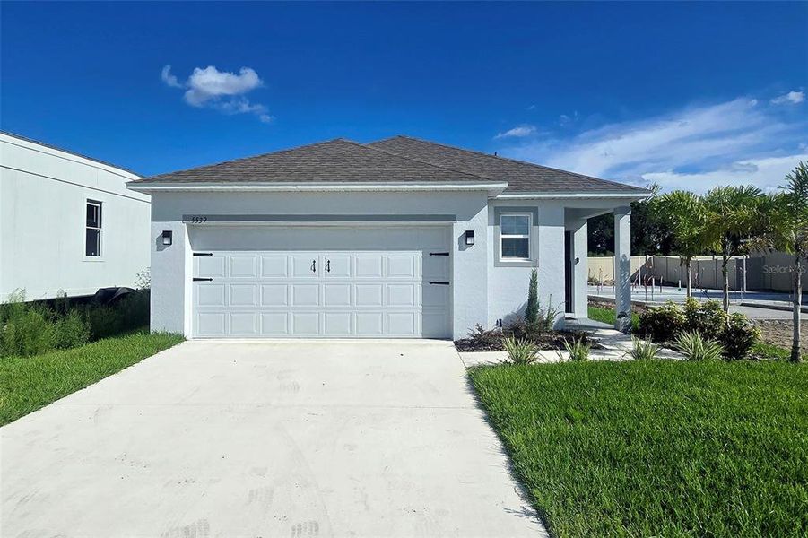 Front exterior of a new home in Hammock Reserve, Haines City, FL, highlighting curb appeal (Image 23). Front exterior of a new home in Hammock Reserve, Haines City, FL, highlighting curb appeal (Image 23).
