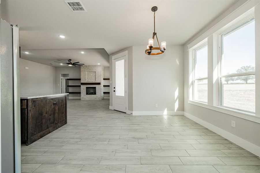 Dining area with tile floors and chandelier. Lots of natural light! Dining area with tile floors and chandelier. Lots of natural light!