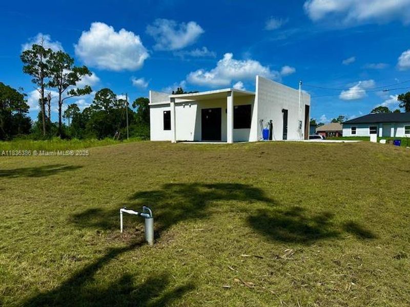 Front exterior of a new home in , Lehigh Acres, FL, highlighting curb appeal (Image 2).
