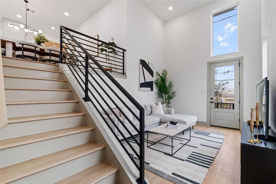 Soaring 18-ft ceilings and a modern split-level layout create an airy, elevated feel in this stylish living space—perfect for both relaxing and entertaining.