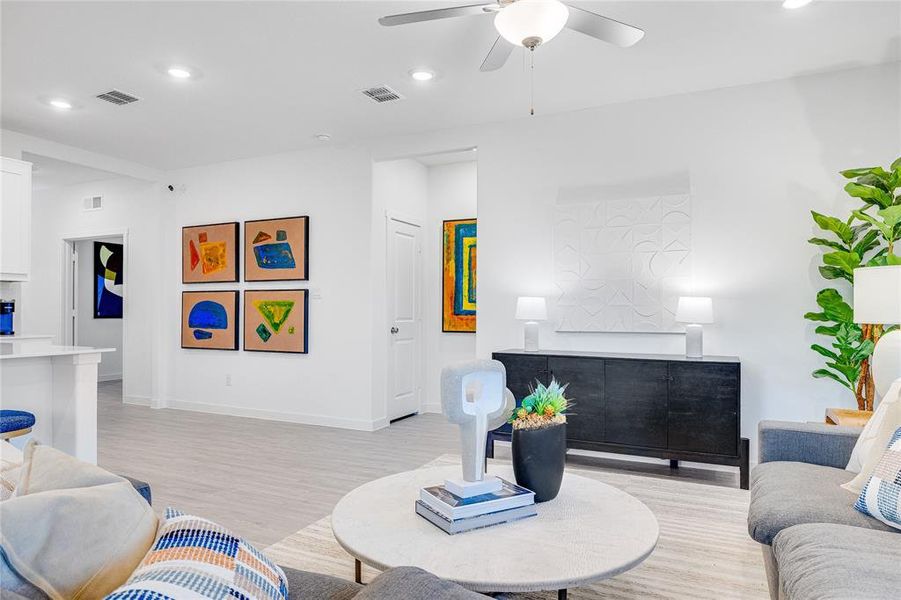 Living room featuring light hardwood / wood-style floors and ceiling fan