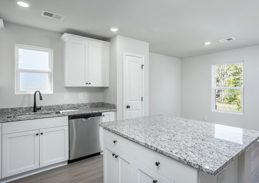 The kitchen island overlooks the dining space.