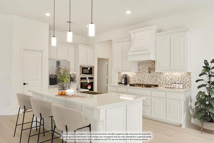White kitchen with large island, pendant lights, mosaic tile backsplash, and stainless steel appliances White kitchen with large island, pendant lights, mosaic tile backsplash, and stainless steel appliances