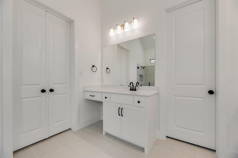 Bathroom featuring a shower stall, vanity, and light tile patterned flooring Bathroom featuring a shower stall, vanity, and light tile patterned flooring