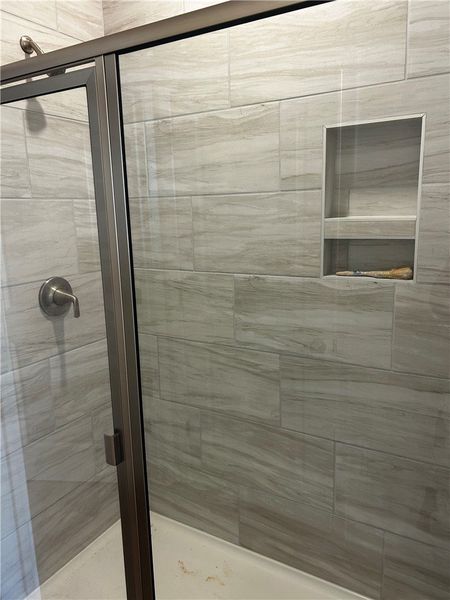Modern shower with sleek fixtures and built-in she