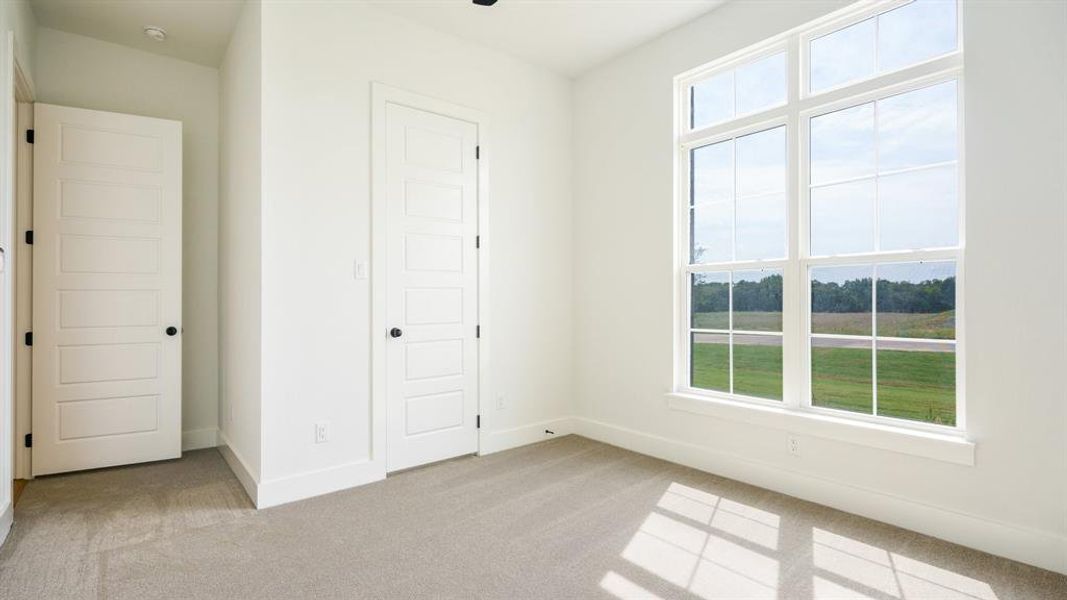 Unfurnished bedroom with a closet and light colored carpet