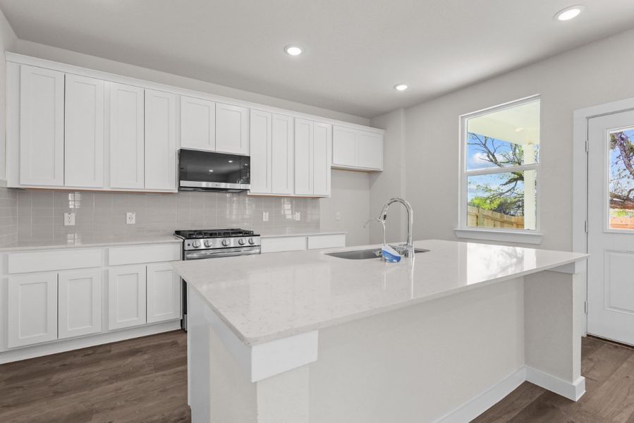 A kitchen with white cabinets. A kitchen with white cabinets.
