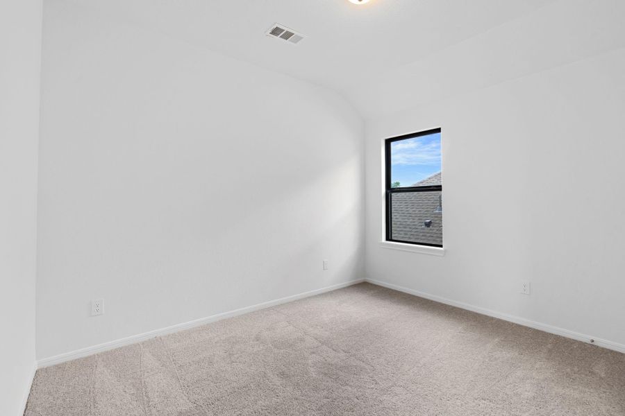 Your secondary bedroom features plush carpet, fresh paint, closet, and a large window that lets in plenty of natural lighting.