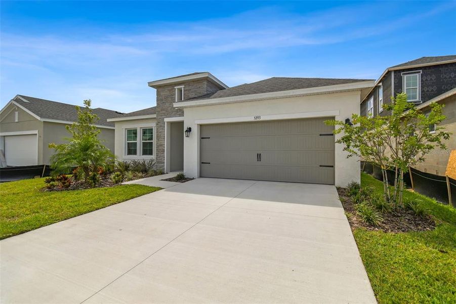 Front exterior of a new home in Waterset, Apollo Beach, FL, highlighting curb appeal (Image 20). Front exterior of a new home in Waterset, Apollo Beach, FL, highlighting curb appeal (Image 20).