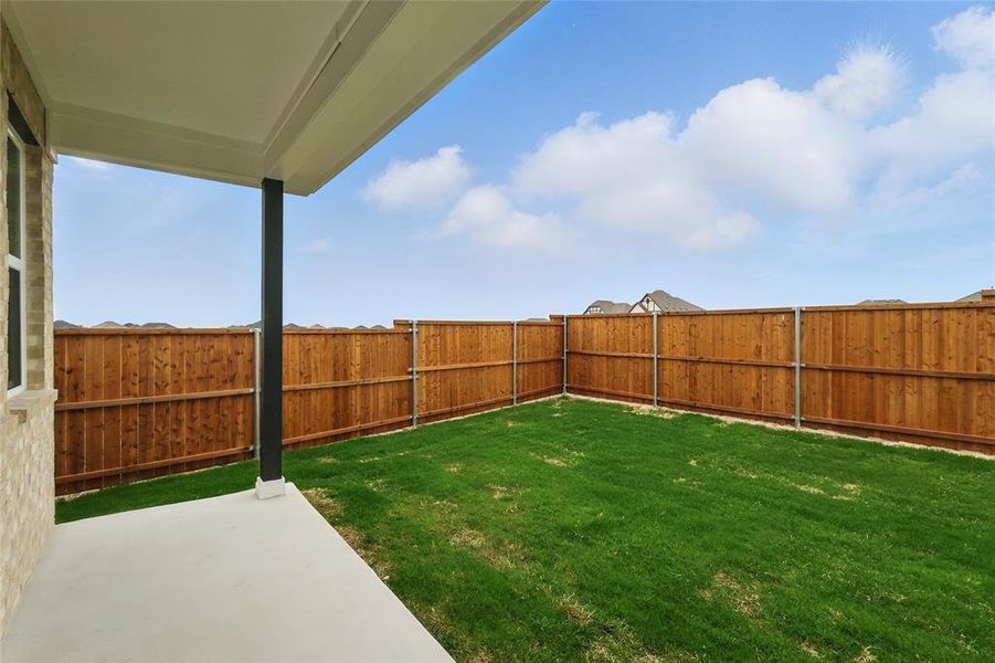 Fenced backyard featuring a patio area