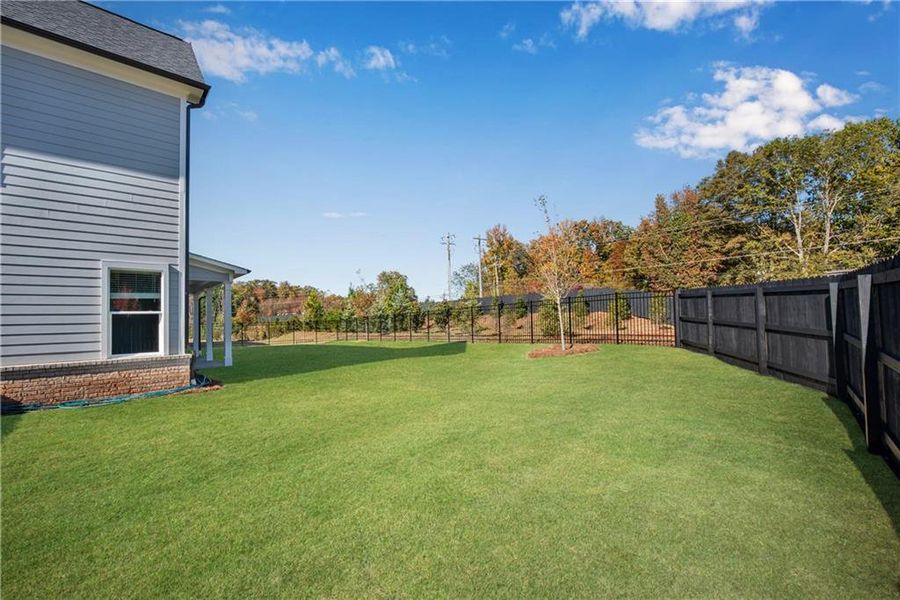 Exterior details and patio area of a home in The Retreat at Caney Creek, Alpharetta (Image 31).