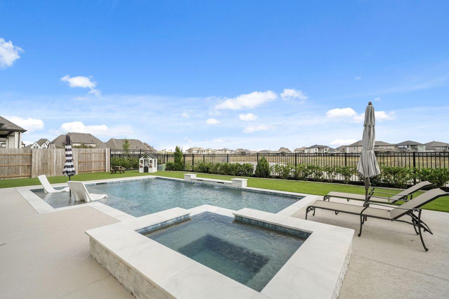 This backyard oasis has it all! Lake views, a tanning shelf, waterfall descents and the waterfall edge spa. Summer is just around the corner!