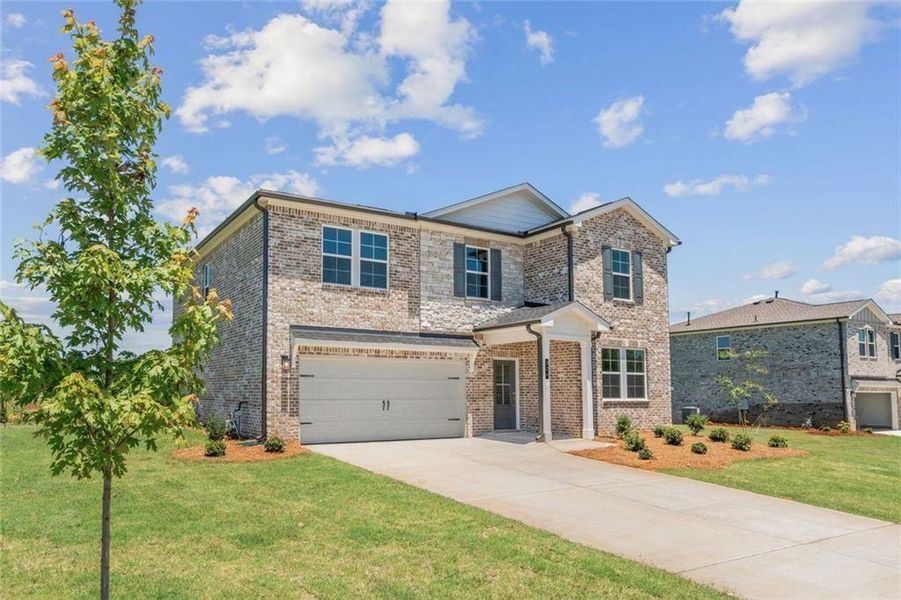 Front exterior of a new home in Walker Grove, McDonough, GA, highlighting curb appeal (Image 2). Front exterior of a new home in Walker Grove, McDonough, GA, highlighting curb appeal (Image 2).