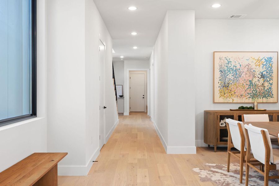 Hallway featuring visible vents, recessed lighting, light wood-type flooring, and baseboards