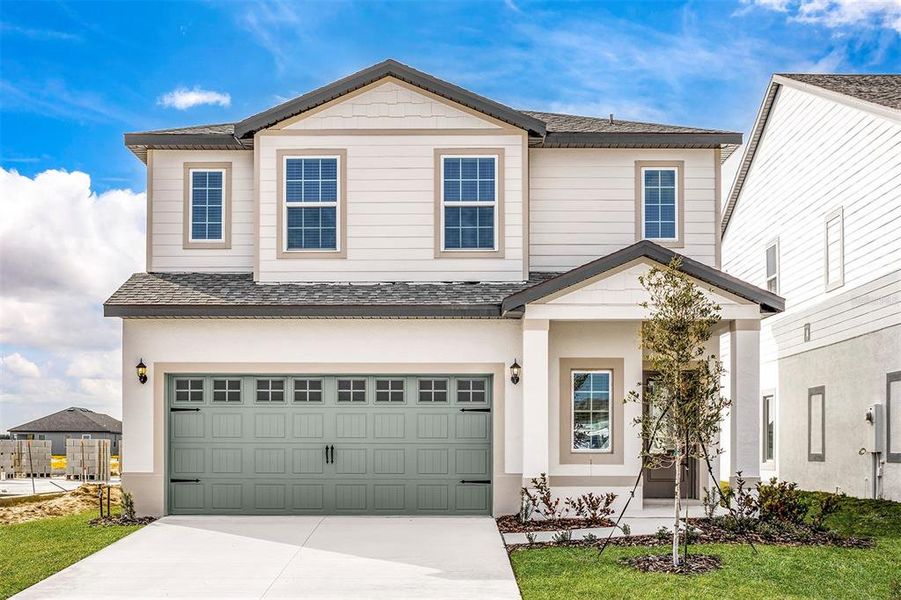 Front exterior of a new home in Gum Lake Preserve, Lake Alfred, FL, highlighting curb appeal (Image 17).