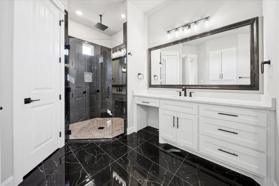 Bathroom with a shower with door and vanity