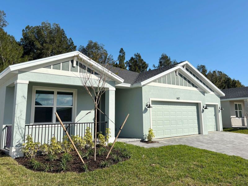 Front exterior of a new home in Hampton Park - Signature Series, Vero Beach, FL, highlighting curb appeal (Image 11). Front exterior of a new home in Hampton Park - Signature Series, Vero Beach, FL, highlighting curb appeal (Image 11).