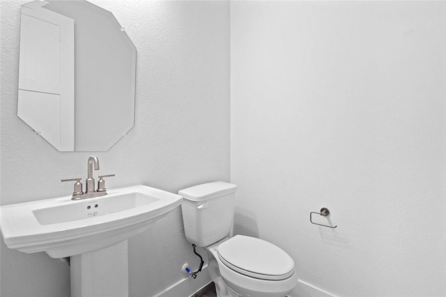 Strategically located on the main level, this half-bath allows guests to freshen up easily without having to navigate through the private areas of the home, such as the bedrooms or personal full bathrooms.
