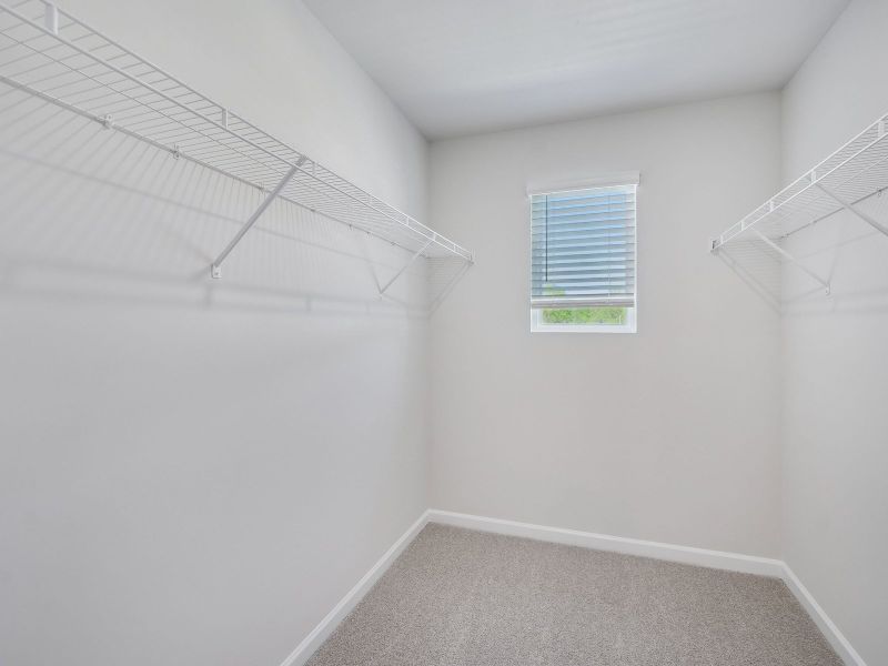 The luxurious primary suite features an ensuite bath with dual sinks and a walk-in closet.