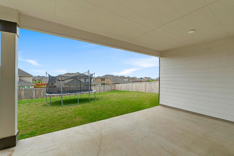 Covered patio with a concrete slab, recessed lighting, and a slatted wall