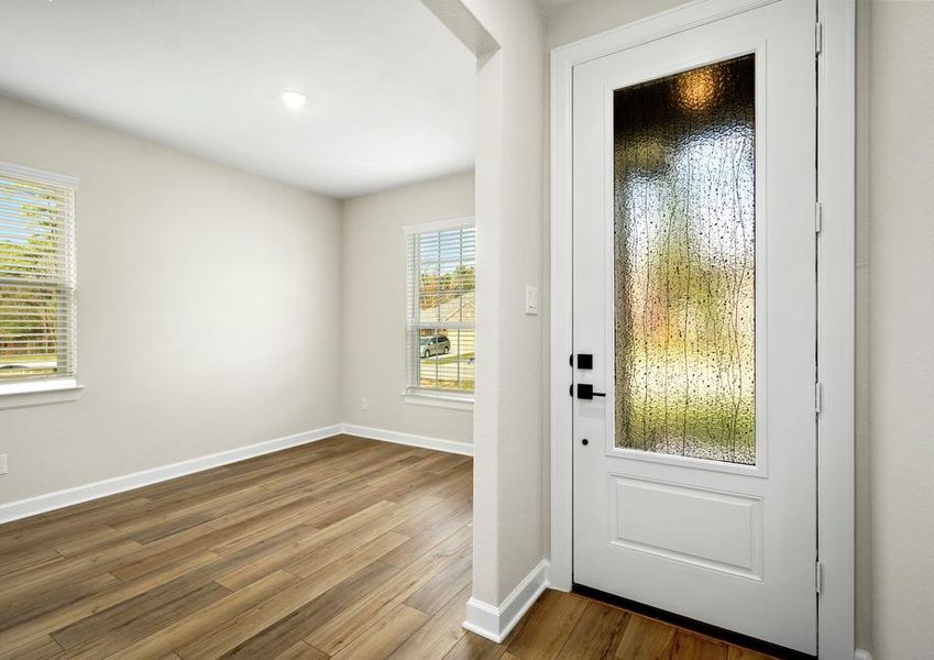 A dining room with two beautiful windows