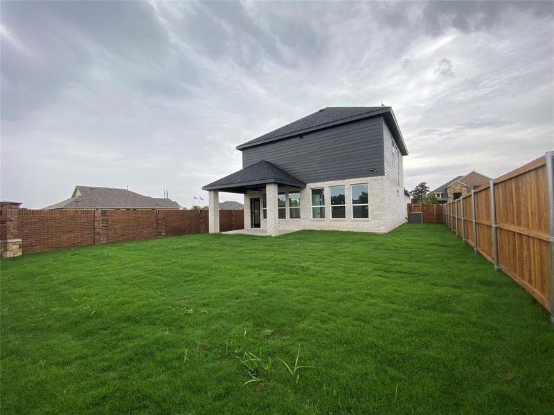 Rear view of property featuring a lawn