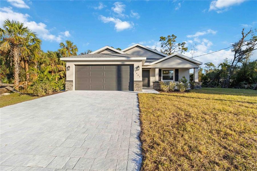 Front exterior of a new home in , North Port, FL, highlighting curb appeal (Image 2). Front exterior of a new home in , North Port, FL, highlighting curb appeal (Image 2).