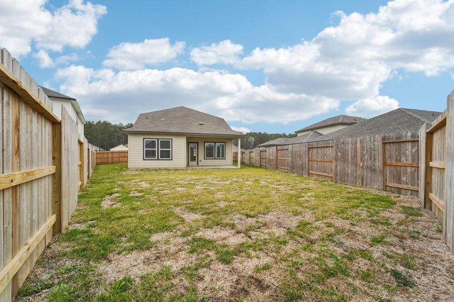 Exterior details and patio area of a home in Landing Meadows - Traditional Series, New Caney (Image 23).