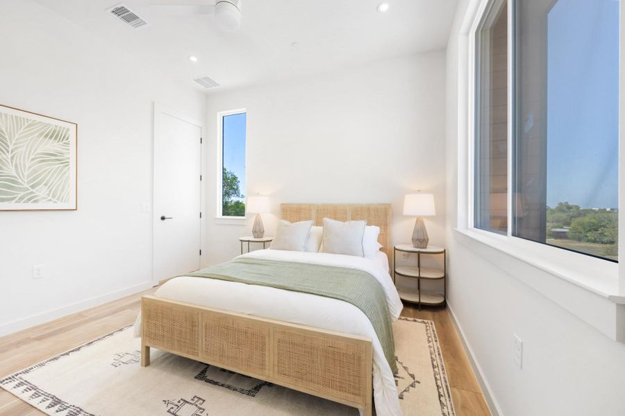 Bedroom with wood finished floors, a ceiling fan, and recessed lighting Bedroom with wood finished floors, a ceiling fan, and recessed lighting