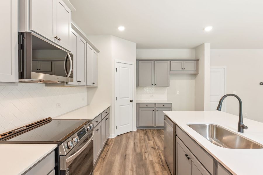 A kitchen with white cabinets. A kitchen with white cabinets.