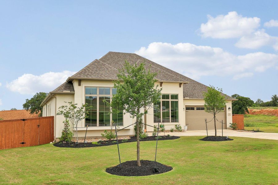 Stucco exterior with a shingle roof
