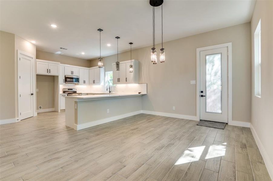 Kitchen with a peninsula, white cabinets, and stainless steel appliances. Kitchen is plumbed for gas Kitchen with a peninsula, white cabinets, and stainless steel appliances. Kitchen is plumbed for gas