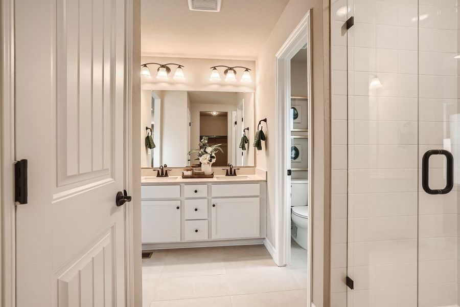 A bathroom with a shower and sink.