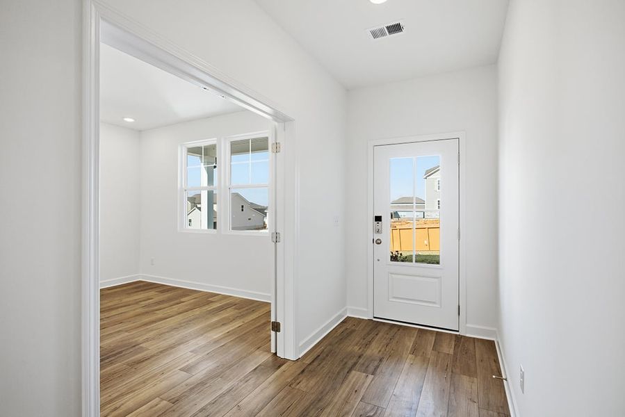 A room with a wood floor and white walls. A room with a wood floor and white walls.