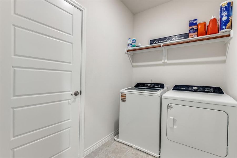 Laundry room featuring light tile patterned floors and washer and clothes dryer Laundry room featuring light tile patterned floors and washer and clothes dryer